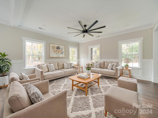 living room with crown molding, hardwood / wood-style floors, and a healthy amount of sunlight