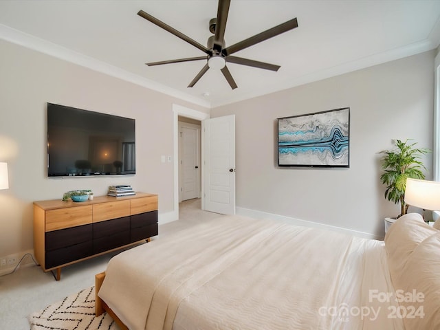 carpeted bedroom with ceiling fan and ornamental molding