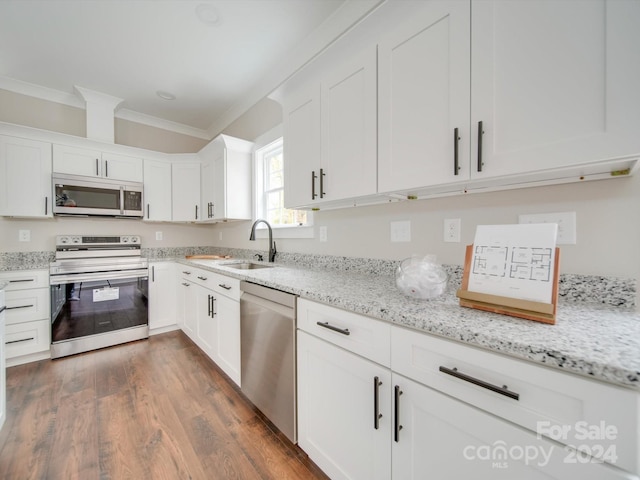 kitchen featuring dark hardwood / wood-style flooring, stainless steel appliances, white cabinetry, and sink