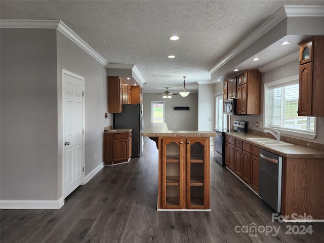 kitchen featuring appliances with stainless steel finishes, a textured ceiling, dark hardwood / wood-style flooring, sink, and ceiling fan