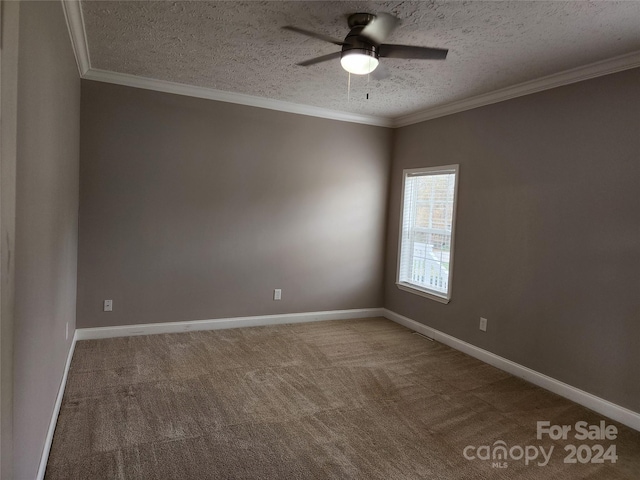 empty room with ornamental molding, carpet, a textured ceiling, and ceiling fan