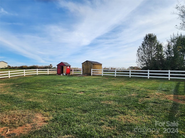 view of yard featuring an outdoor structure and a rural view