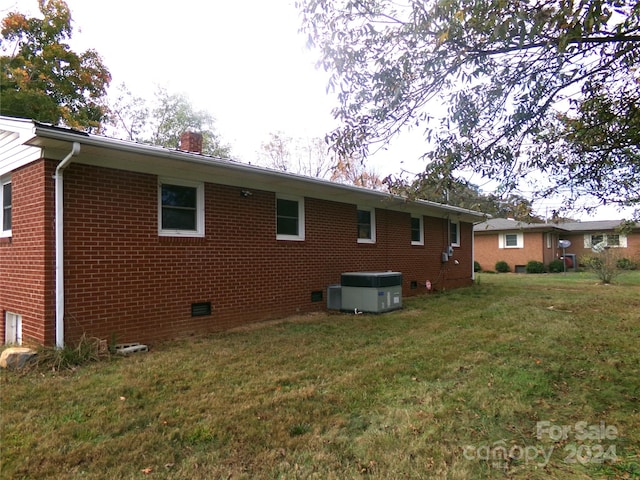 back of property featuring a lawn