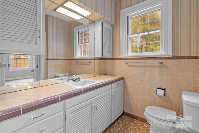 bathroom with tile walls and vanity