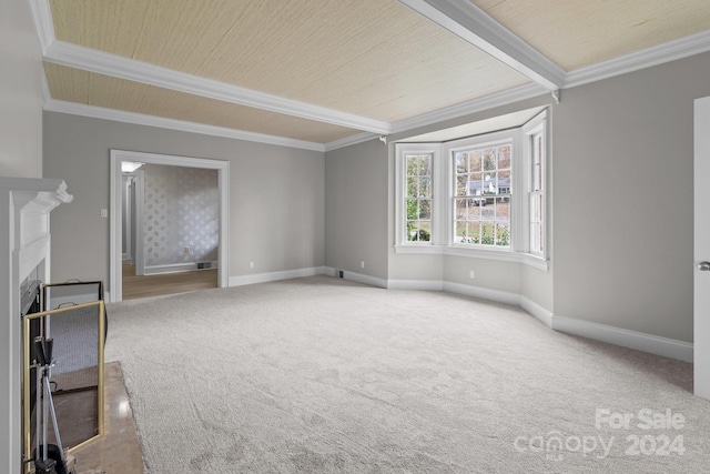 spare room featuring beam ceiling, crown molding, and carpet