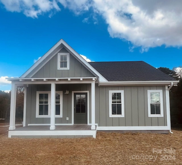 back of house featuring a porch