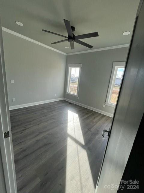 unfurnished room featuring ceiling fan, dark hardwood / wood-style floors, and ornamental molding