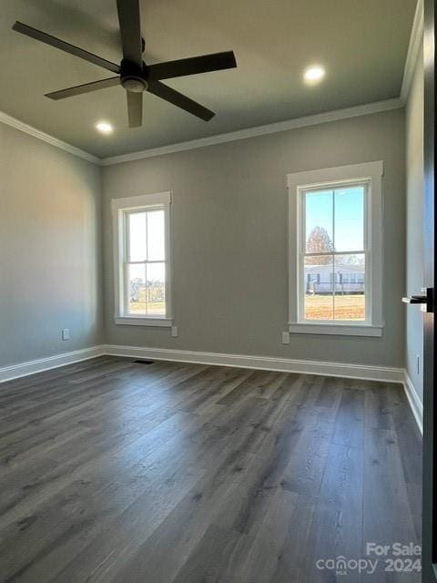 spare room featuring ceiling fan, dark wood-type flooring, and ornamental molding