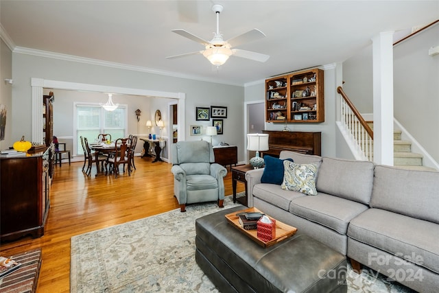 living room with hardwood / wood-style floors, ceiling fan, and crown molding