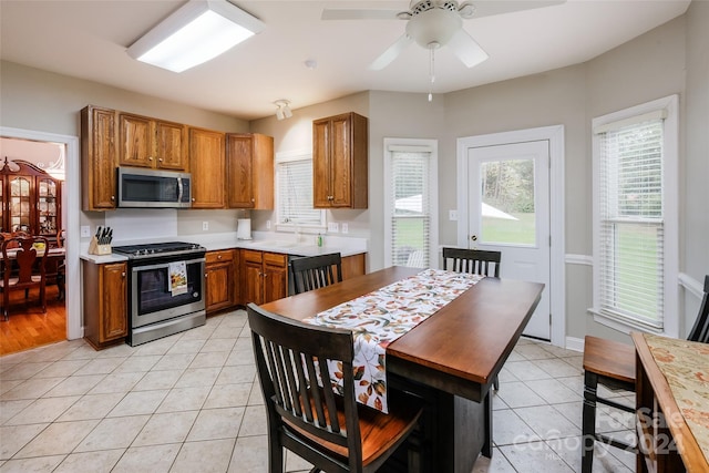 kitchen featuring appliances with stainless steel finishes, ceiling fan, and light tile patterned flooring