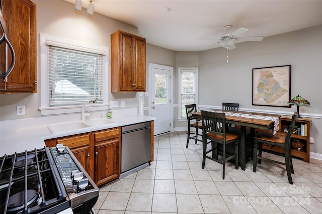 kitchen featuring stainless steel dishwasher, ceiling fan, a healthy amount of sunlight, and sink