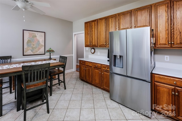 kitchen with stainless steel fridge, ceiling fan, and light tile patterned flooring