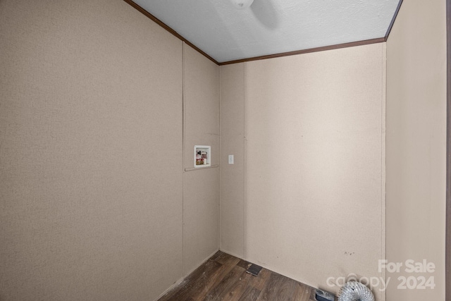 laundry room featuring dark wood-type flooring, washer hookup, a textured ceiling, and crown molding