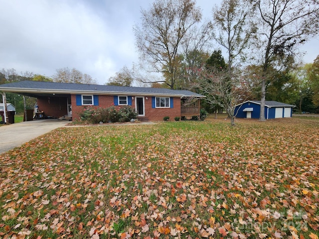 ranch-style house featuring a front yard and a carport