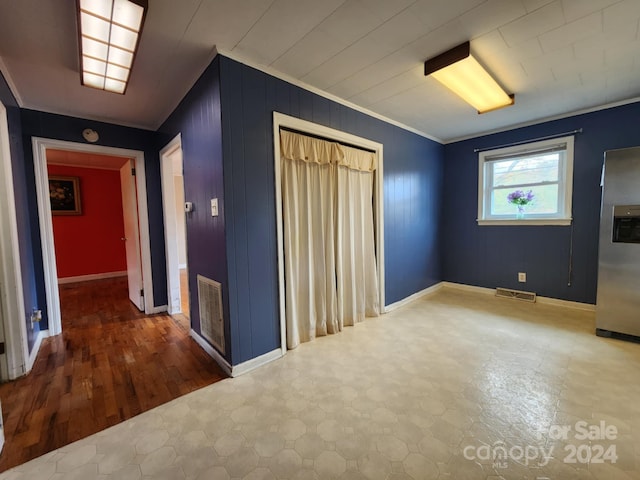 interior space featuring hardwood / wood-style flooring and ornamental molding