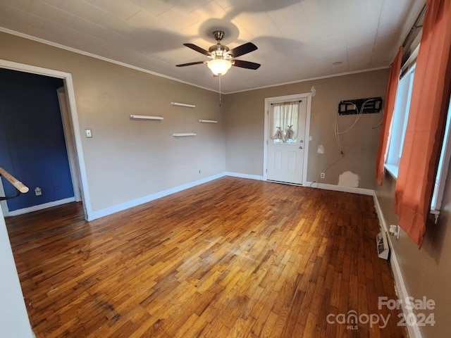 entryway featuring plenty of natural light, hardwood / wood-style floors, ceiling fan, and crown molding