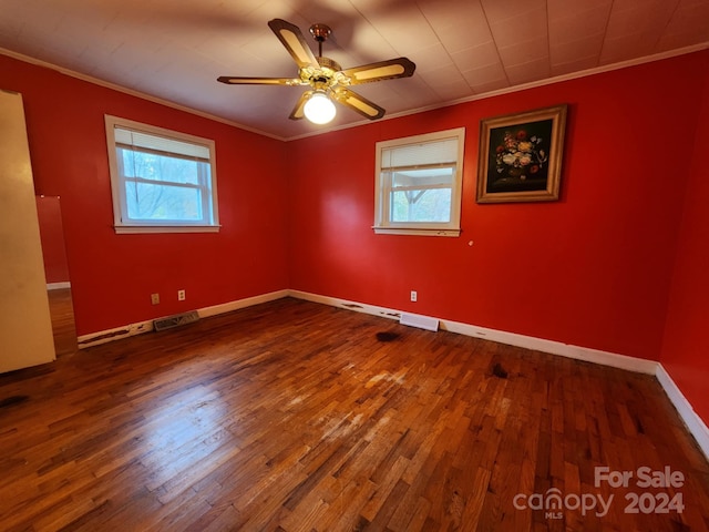 spare room with hardwood / wood-style floors, ceiling fan, and crown molding