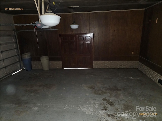 garage featuring wood walls