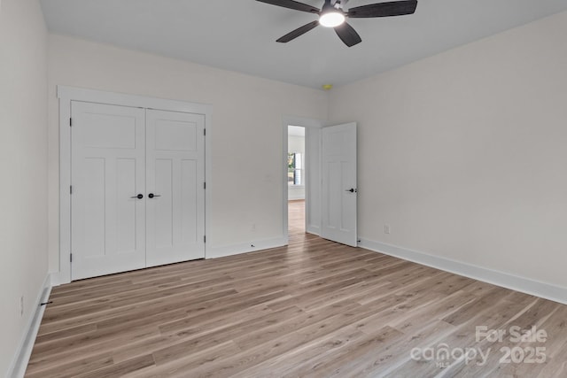 unfurnished bedroom with ceiling fan, light hardwood / wood-style floors, and a closet