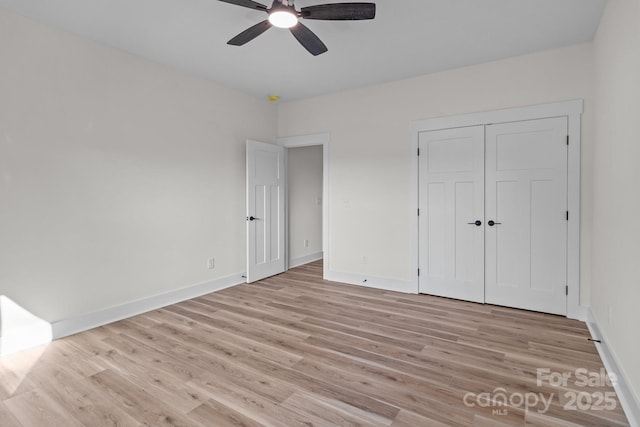 unfurnished bedroom with ceiling fan, a closet, and light hardwood / wood-style floors