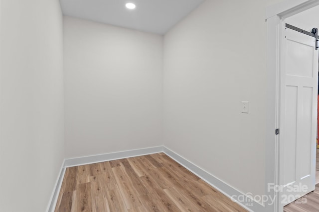 interior space featuring a barn door and light wood-type flooring