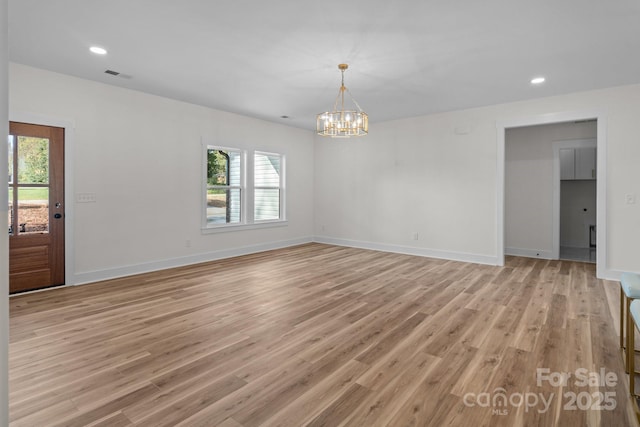 interior space featuring a chandelier and light hardwood / wood-style floors