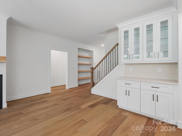 interior space with light hardwood / wood-style floors and crown molding