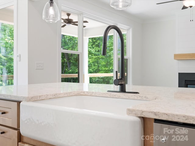 bathroom with sink, ceiling fan, and a fireplace