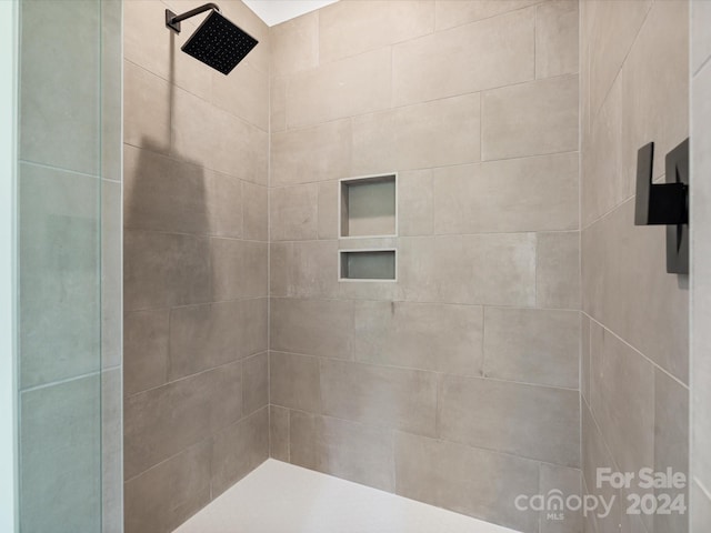 bathroom with tiled shower