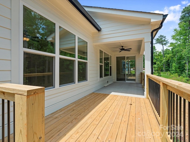 wooden terrace featuring ceiling fan