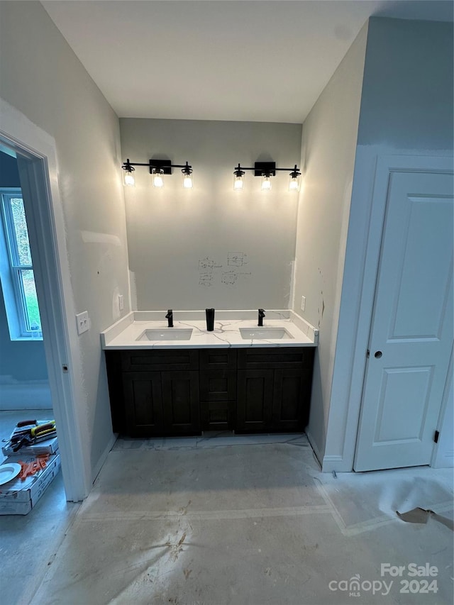 bathroom with vanity and concrete floors