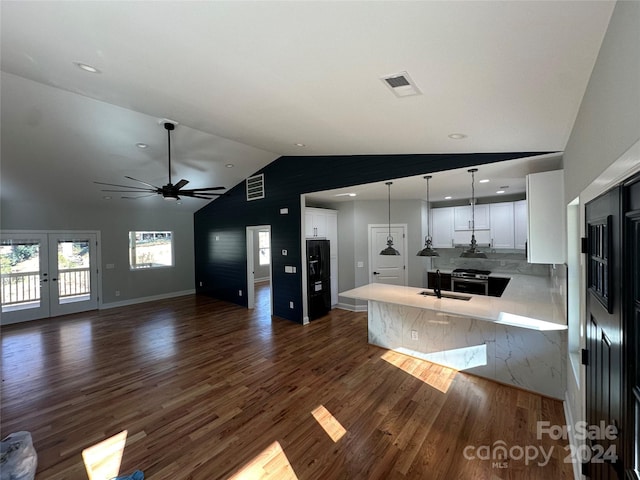 kitchen featuring lofted ceiling, dark wood-type flooring, white cabinets, sink, and kitchen peninsula