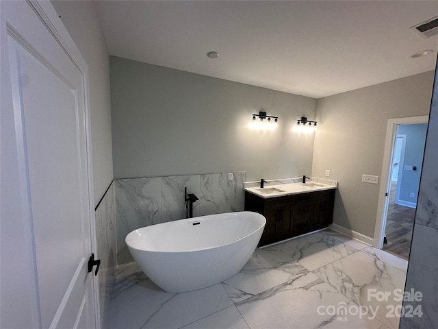 bathroom with vanity and a bath