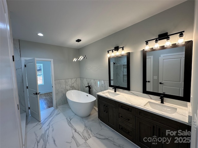 bathroom featuring vanity, separate shower and tub, and tile walls