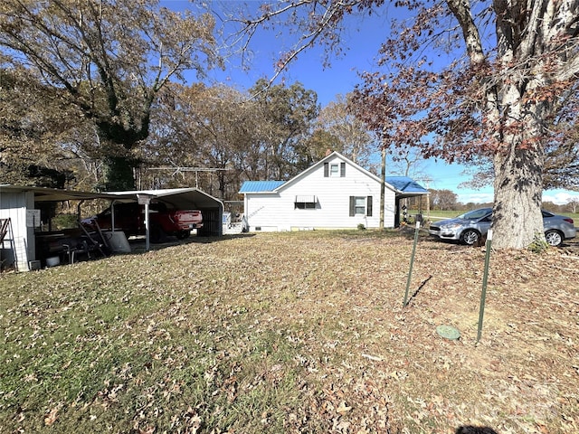 exterior space featuring a carport and a yard