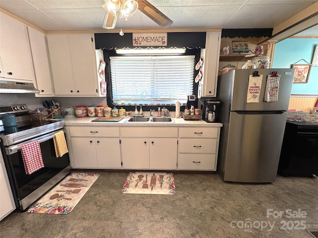 kitchen with appliances with stainless steel finishes, sink, white cabinets, and ceiling fan