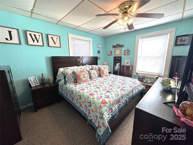 bedroom with a drop ceiling and ceiling fan