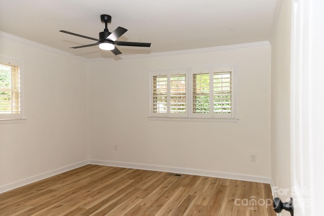 empty room featuring crown molding, ceiling fan, a healthy amount of sunlight, and light hardwood / wood-style floors