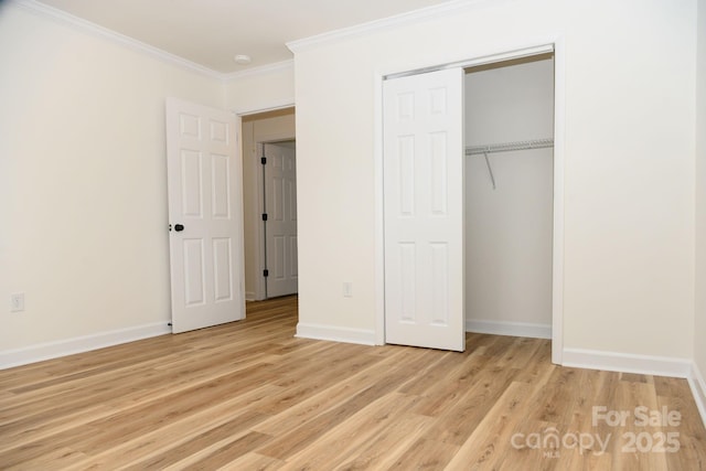 unfurnished bedroom with a closet, light hardwood / wood-style floors, and ornamental molding