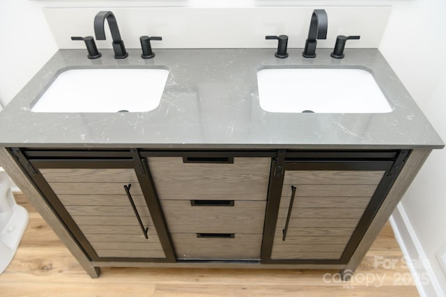 interior details with wood-type flooring and vanity