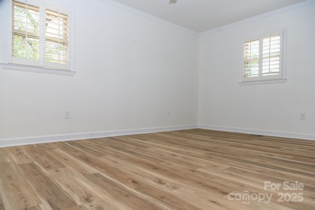 spare room featuring wood-type flooring and ornamental molding