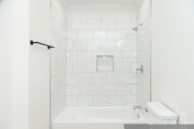 bathroom with tiled shower / bath, ornamental molding, and toilet