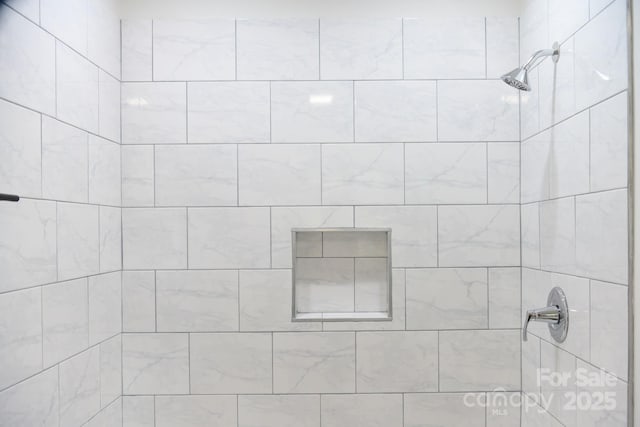 bathroom with a tile shower