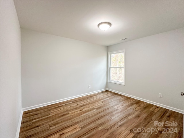 unfurnished room with light wood-type flooring