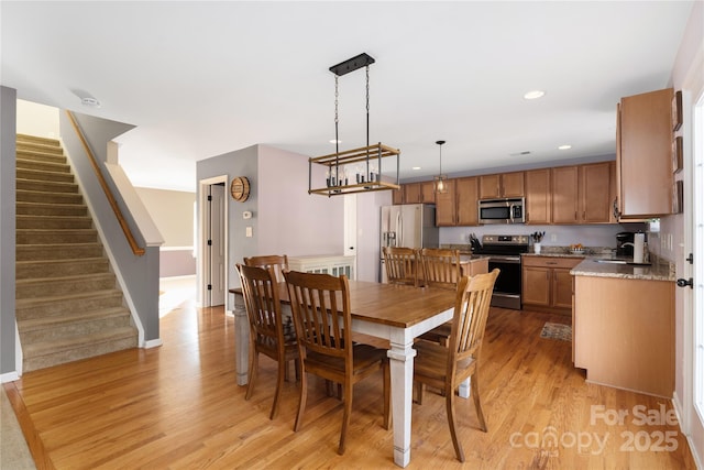 dining area featuring sink and light hardwood / wood-style floors