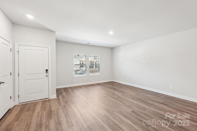 unfurnished room with hardwood / wood-style flooring