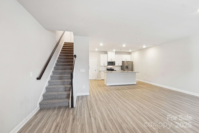 unfurnished living room featuring light hardwood / wood-style flooring