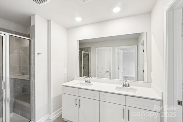 bathroom featuring walk in shower and vanity