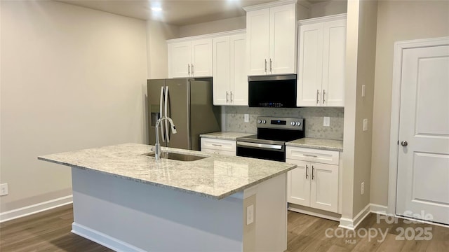 kitchen featuring an island with sink, appliances with stainless steel finishes, sink, and white cabinets