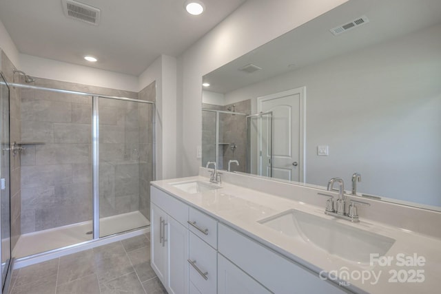 bathroom featuring walk in shower, tile patterned floors, and vanity